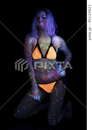 Portrait of Beautiful Fashion Woman in Neon UF Light. Model Girl with Fluorescent Creative Portrait of Beautiful Fashion Woman in Neon UF Light. Model Girl with Fluorescent Creative 40129921