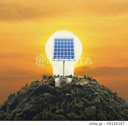 Solar cell inside light bulb on pile of soil Solar cell inside light bulb on pile of soil 40130167