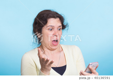 Angry aggressive woman on blue background 40136591