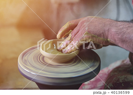 Creating a jar or vase of white clay close-up Creating a jar or vase of white clay close-up 40136599