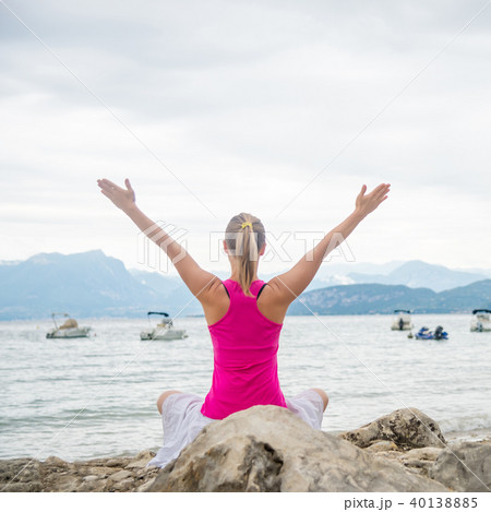 Woman meditating at the lake 40138885
