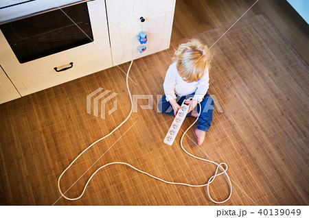 Toddler boy in dangerous situation at home. Child safety concept. Toddler boy in dangerous situation at home. Child safety concept. 40139049