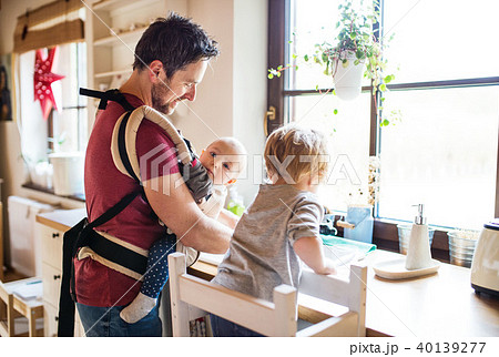 Father and two toddlers washing up the dishes. Father and two toddlers washing up the dishes. 40139277