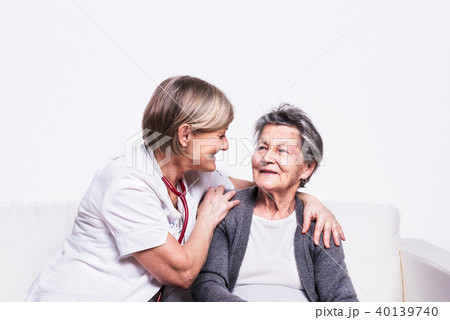 Studio portrait of a senior nurse and an elderly woman. 40139740