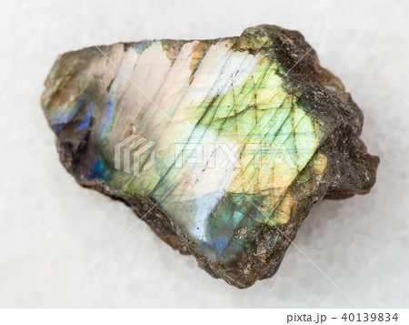 polished slab of labradorite stone on white marble 40139834