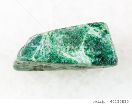 polished green jadeite stone on white polished green jadeite stone on white 40139839