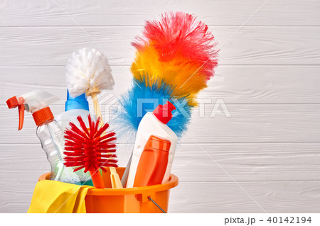 Bottles of cleaning liquid in bucket. 40142194