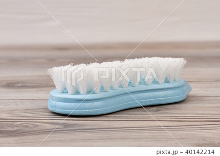 Blue plastic brush on wooden background. Blue plastic brush on wooden background. 40142214