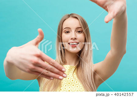 Close-up Young Caucasian woman face and eye care and she making frame with hands isolated over 40142557