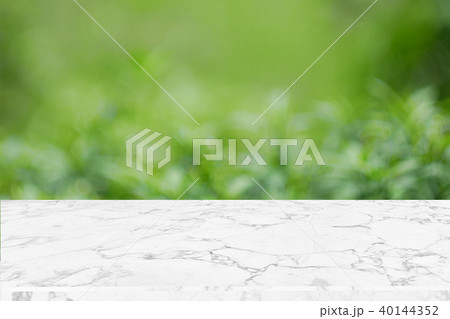 Blank marble table top on green nature abstract bokeh background f 40144352