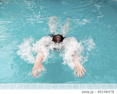young man swims up to the termination of a path an young man swims up to the termination of a path an 40148478