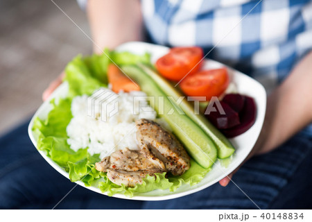 Girl with a plate of vegetables in hands 40148834