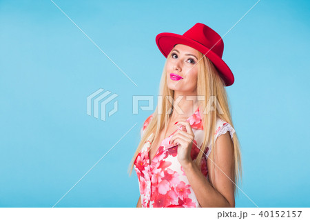 Beautiful woman with long straight blond hair. Fashion model posing at studio on blue background 40152157
