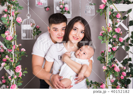 Indoor portrait of asian mixed race family with infant baby Indoor portrait of asian mixed race family with infant baby 40152182