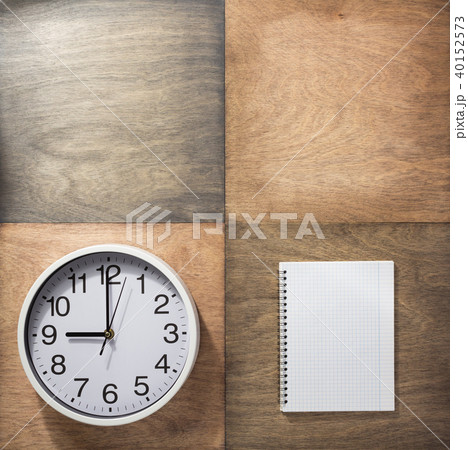 notebook and wall clock at wooden background 40152573