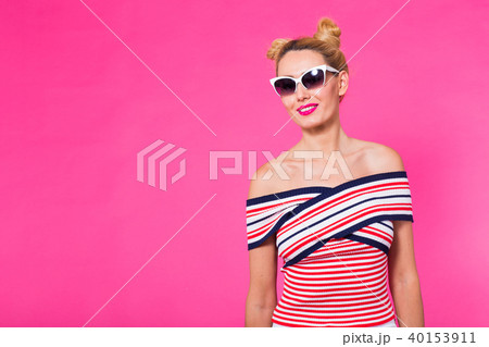 travel, vacation, summer holidays concept - portrait of happy young woman in sunglasses on pink 40153911