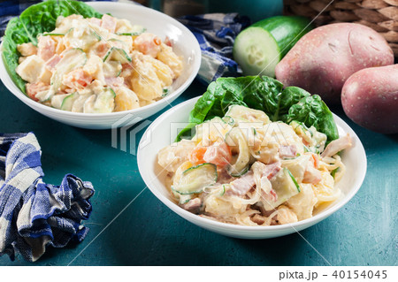 Delicious potato salad with ham, egg and cucumber Delicious potato salad with ham, egg and cucumber 40154045