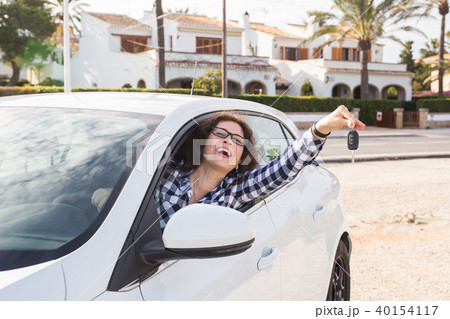 Young happy woman test drive new car and showing key. Car purchase or rental concept 40154117