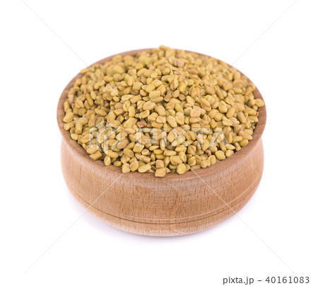 Fenugreek seeds in wooden bowl, isolated on white background 40161083