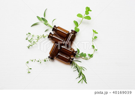 Top view, Bottle of essential oil with herbs. 40169039