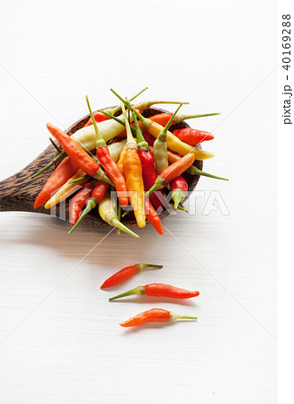 Colorful chili peppers on white. Colorful chili peppers on white. 40169288