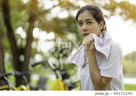 Young woman tried to exercise and sitting, relax Young woman tried to exercise and sitting, relax 40171145