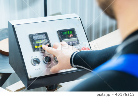 a close-up of the operator the man presses the button on the control panel with the control devices 40176315