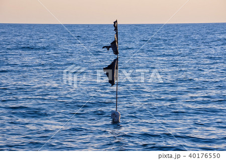 black buoy in the sea 40176550