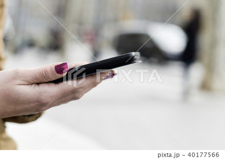 woman using a tablet in the street. 40177566