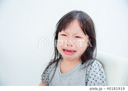 Little asian girl crying alone in white room Little asian girl crying alone in white room 40181919