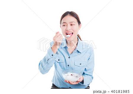Beautiful  woman eating yogurt with fruits  40181985
