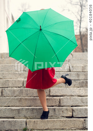 The girl behind an umbrella The girl behind an umbrella 40184056