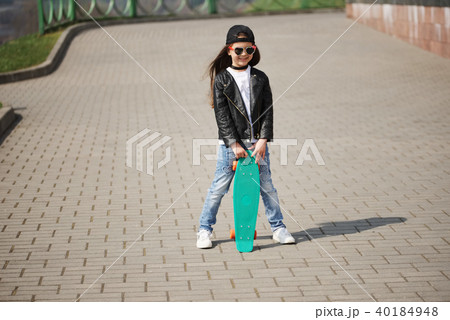 little girl with skateboard on the street little girl with skateboard on the street 40184948