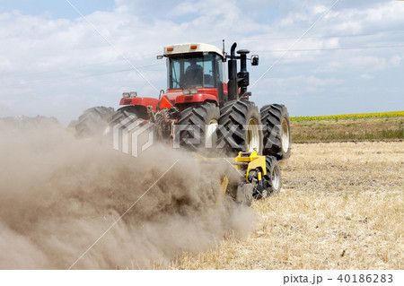 Tractor plowing field at summer 40186283