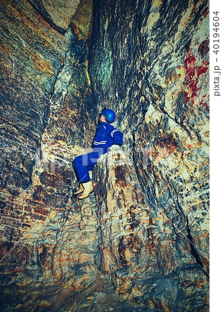 Employee in safety suit in medieval tunnel 40194604