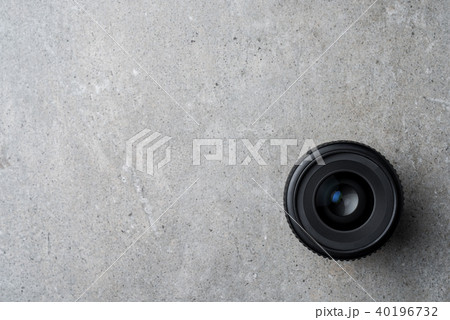 Modern camera lens on gray stone table Modern camera lens on gray stone table 40196732