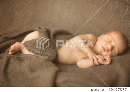 Little sleeping newborn baby in wrap creamy 40197377