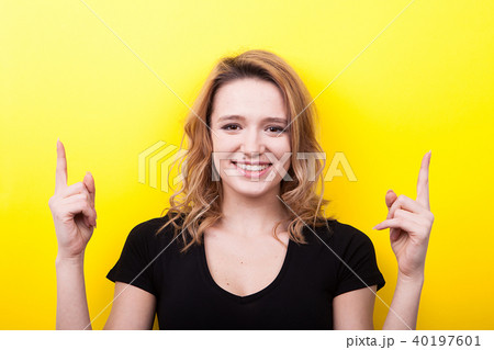 Happy smiling woman pointing up 40197601