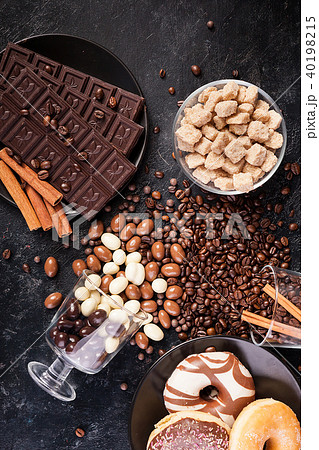 Spilled glasses with coffee beans and peanuts in chocolate Spilled glasses with coffee beans and peanuts in chocolate 40198215