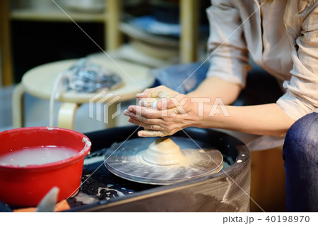 hands of woman making clay object 40198970