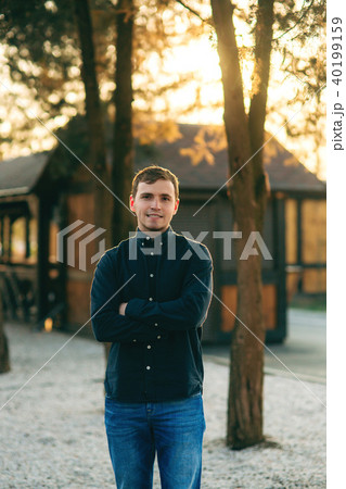 A young man in a park in a dark blue shirt. Spring A young man in a park in a dark blue shirt. Spring 40199159