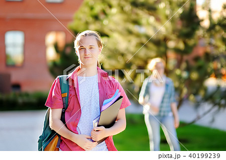 Smart successful young student in University campus Smart successful young student in University campus 40199239