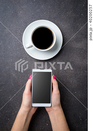 Woman holding smart phone. Top view 40200257