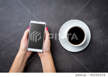 Woman holding smart phone. Top view 40200258