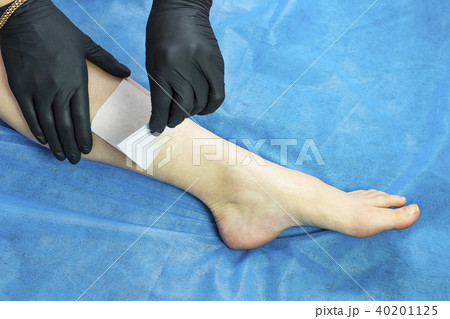 Process depilation female legs and hands in a beau Process depilation female legs and hands in a beau 40201125
