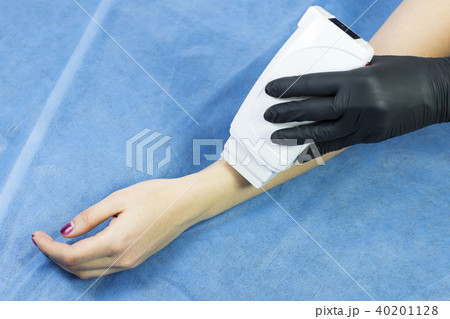 Process depilation female legs and hands in a beau Process depilation female legs and hands in a beau 40201128