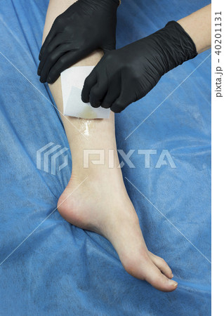 Process depilation female legs and hands in a beau Process depilation female legs and hands in a beau 40201131