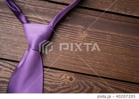 Purple necktie on wooden table Purple necktie on wooden table 40207205