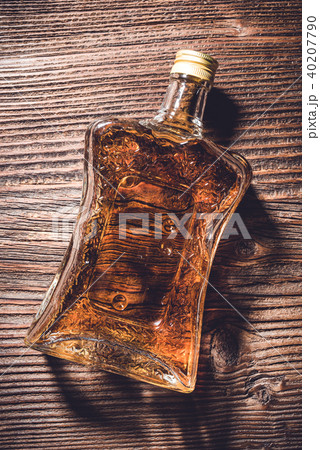 Bottle of whiskey on wooden table. Close up Bottle of whiskey on wooden table. Close up 40207790