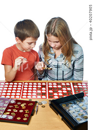Boy and girl are considering coin collection Boy and girl are considering coin collection 40207905